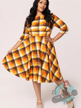 Plus size pinup girl in Fall swing dress