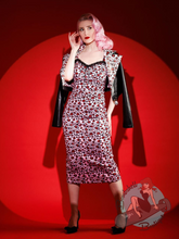 Pinup girl wearing pink leopard print wiggle dress in 1950s style pencil dress rockabilly style