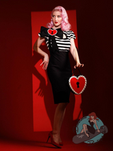 Pinup girl wearing black and white 1950s style wiggle dress for sexy rockabilly girl clothing look