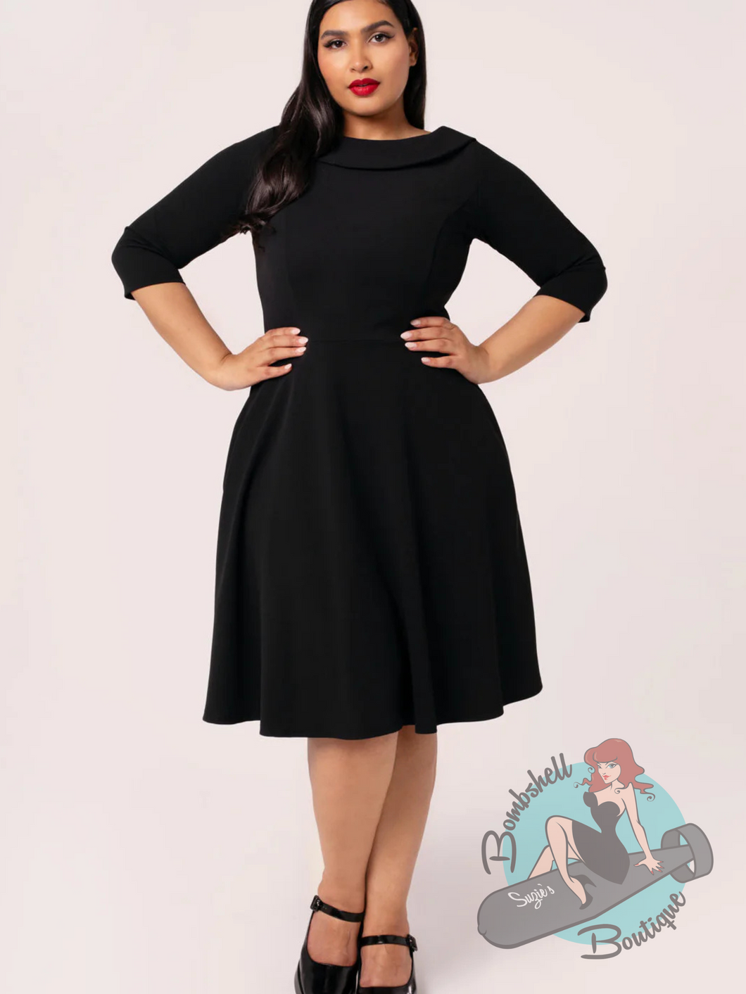Plus size pinup girl wearing classic black Audrey Hepburn style vintage dress