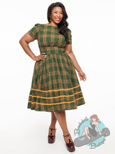 Plus size vintage pinup girl plaid green and orange swing dress with ric rac trim.