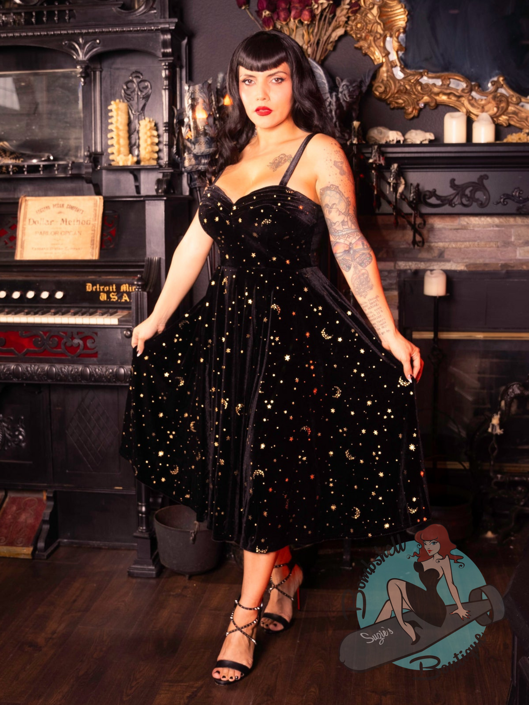Black stretch velvet party dress with gold stars design in 1950s pinup vintage style for Christmas or holiday party.