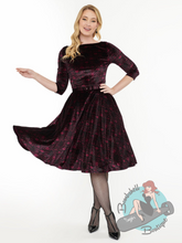 Black and magenta stretch velvet 1950s vintage style swing dress with Nightmare Before Christmas Jack Skellington design in standard and plus size pinup girl.