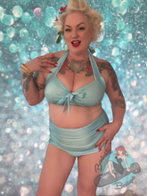 Two piece vintage Marilyn Monroe style pinup bathing suit. This vintage inspired swimsuit comes in blue and red tiki pattern.
