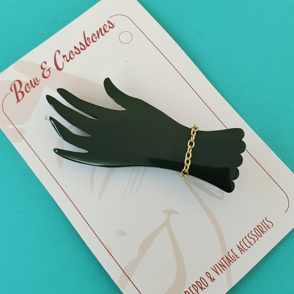 Bow & Crossbones Lillianna Hand Brooch Black Bow and Crossbones Canada black acrylic hand with gold chain art deco retro vintage pinup 40s 50s bakelite jewellery Canadian Pin-Up Shop Suzie's Bombshell Boutique Port Dover
