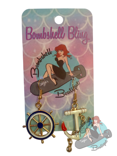 Earring set with anchor and wheel design on a 'Bombshell Bling' branded card.