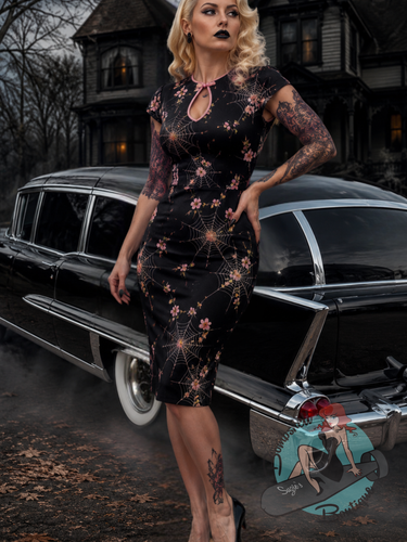 Gothic style pinup model wearing Banned Retro Canada vintage-style gothic wiggle dress with a spiderweb and floral pattern.