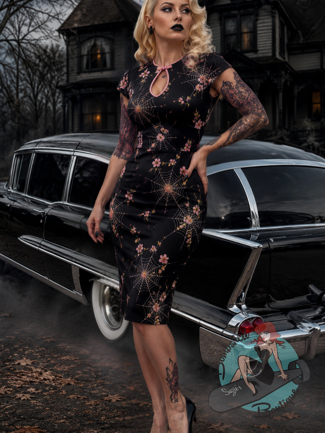 Gothic style pinup model wearing Banned Retro Canada vintage-style gothic wiggle dress with a spiderweb and floral pattern.