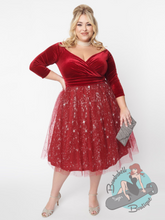 A burgundy velvet and tulle swing dress with silver stars in the style of a 1950s prom dress. Perfect for Christmas holiday parties.