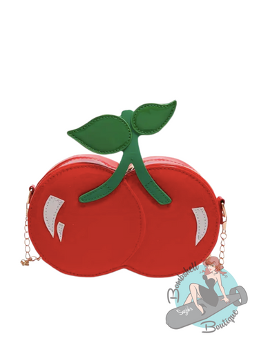 Red cherry-shaped purse with green stem on a white background