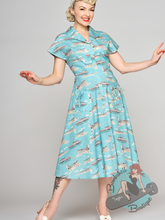 Blue shirt dress with print of Brighton seaside. This classic house dress style is perfect for a vintage pin-up girl who wants to have a 1950s look.