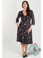Black swing dress with traditional tattoo design print. This is a fit and flare pin up dress perfect for rockabilly style ladies.