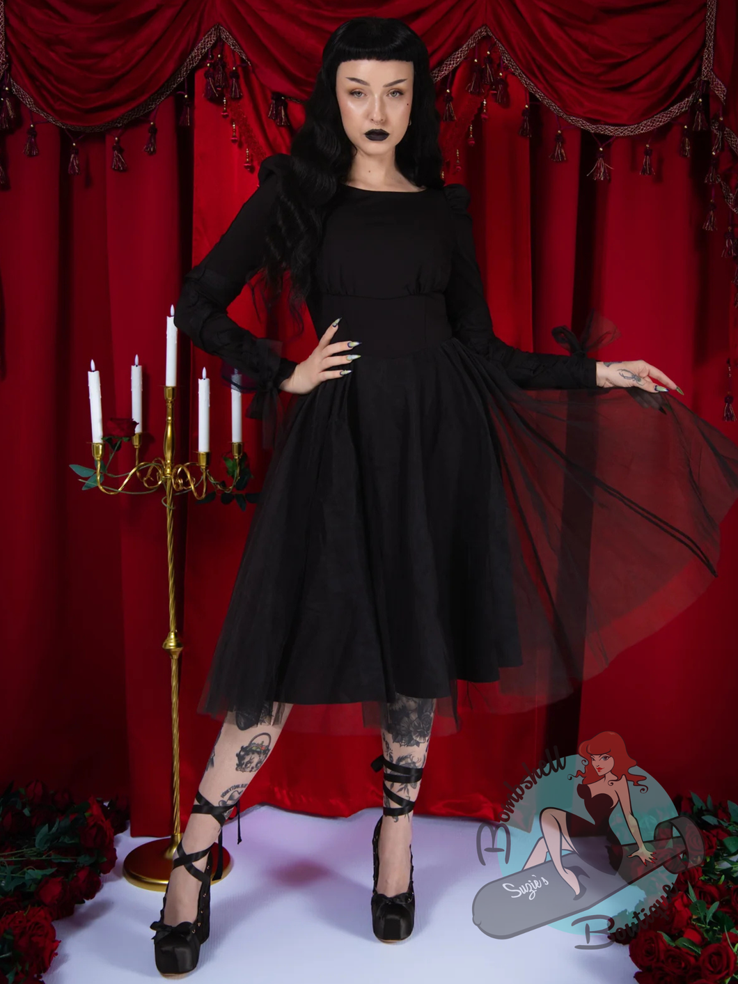 A woman wearing Elle Rebel Canada goth clothing black long-sleeve swing dress with a sheer tulle overlay