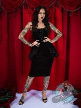 Goth pinup woman wearing black velvet Elle Rebel Canada peplum dress
