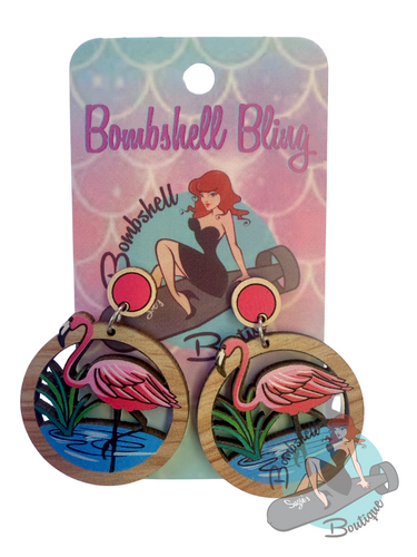 Flamingo earrings on a 'Bombshell Bling' branded card with a vintage-style illustration.