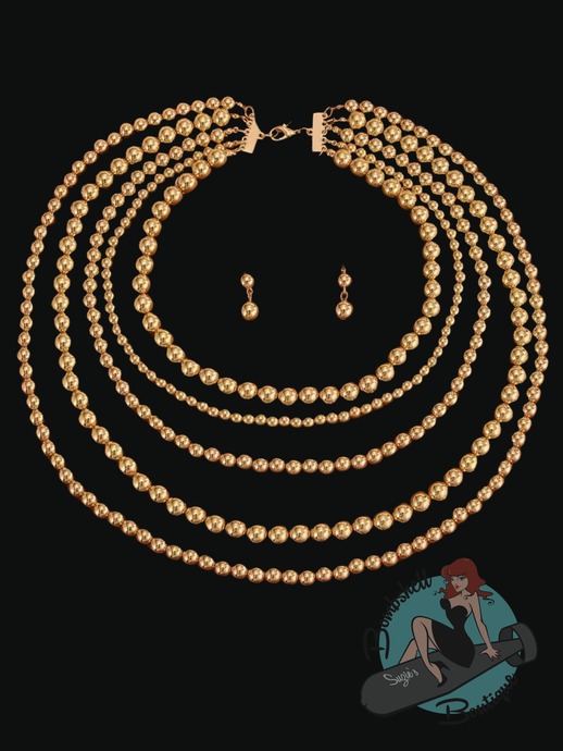 Gold beaded necklace and earrings on a black background