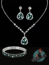 Jewelry set with necklace, earrings, and bracelet featuring gemstones on a black background.