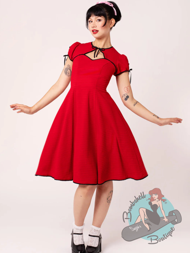 Pinup woman wearing hell bunny canada red swing dress with bolero style top