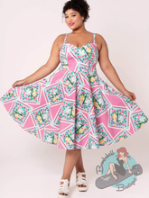 Plus sized woman in pinup swing dress with 1950s style full skirt and summer print