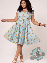 Pinup woman wearing plus size swing dress with spring theme
