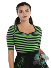 Pinup girl wearing goth style black and green striped top