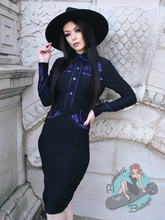 Pinup girl in southern gothic style black western dress with purple embroidery 