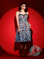 Brunette Pinup girl wearing 1950s vintage style swing dress in blue