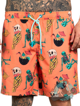 Orange swim shorts for men. Pattern depicts skulls, skeletons, tiki drinks.