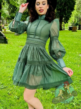 goth pinup woman wearing green lace trimmed vintage dress