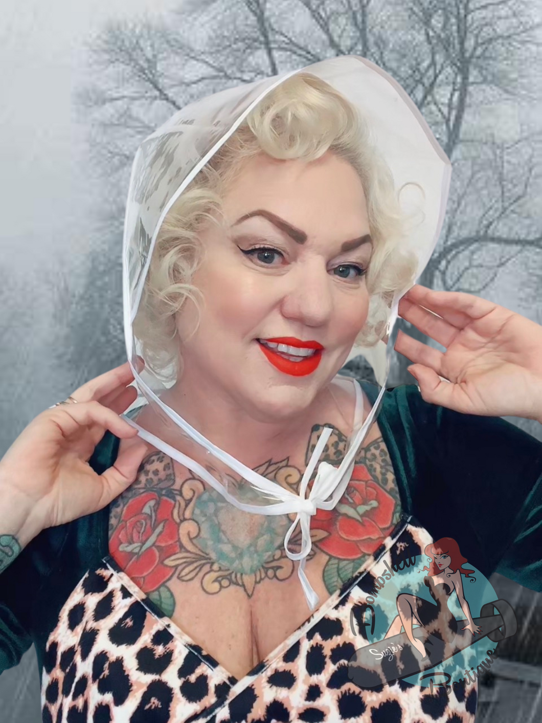 Pin Up Girl wearing clear plastic rain hat. This vintage inspired Rain bonnet is perfect for keeping your retro styled hair in place.