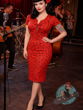 Rockabilly pinup girl in fitted red dress with cherry designs