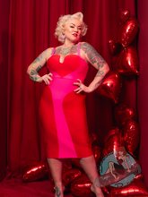 Suzie Bombshell wearing a pink and red heart bodice bandage dress.