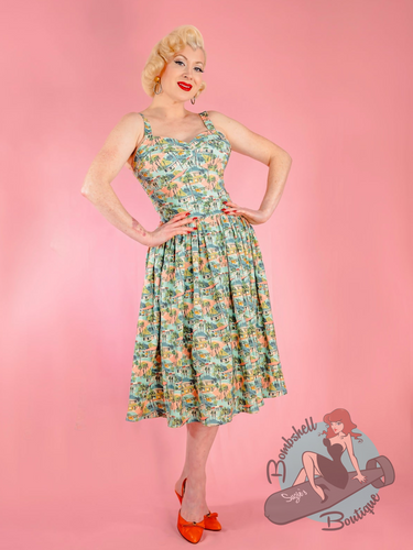 Blonde pinup girl, Miss Audrey Monroe, wearing Elle Rebel 150s vintage style romper swing skirt set in midcentury modern palm springs print