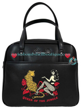 Sourpuss Canada Sourpuss Queen of the Jungle Bowler Bag is a black handbag in style of bowling bag with image of bettie page style pinup girl wearing fishnets with black hair and a leopard wild cat altfashion retro vintage goth pinup rockabilly purse Canadian Pin-Up Shop Suzie's Bombshell Boutique
