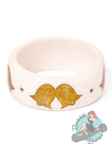 Wide white bangle with glitter gold bell design and starburst inlaid gems. The perfect Christmas accessory for your pin up holiday dress.