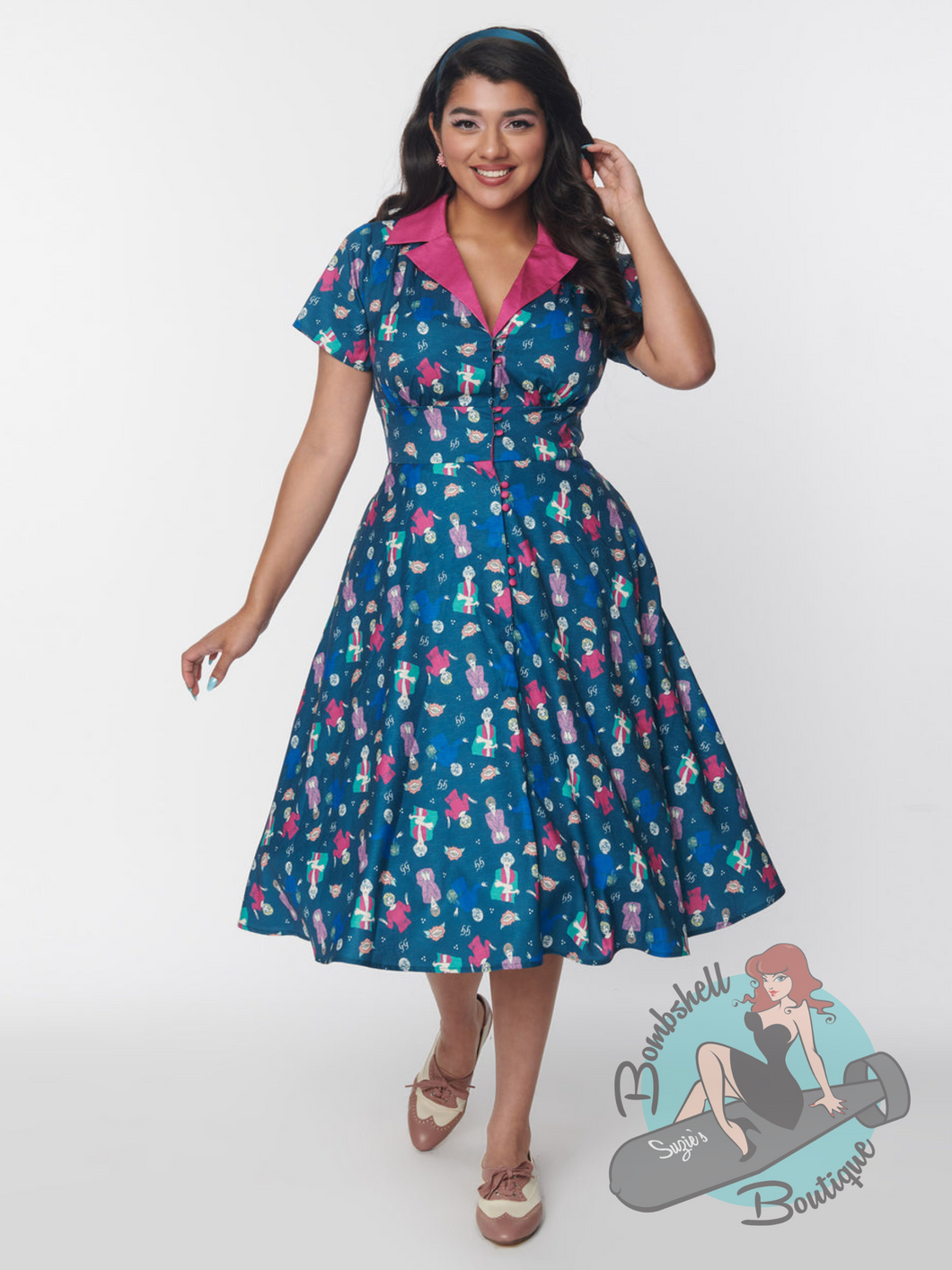 1950s style pin up swing dress in teal with accenting pink collar and all over print of the Golden Girls. This nostalgic dress has pockets.