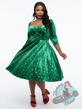 Plus size pinup dress in green stretch velvet with sparkly silver snowflakes. Perfect for a vintage inspired Christmas look.