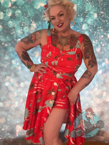 Red tiki pattern gathered swing skirt with mother of pearl buttons and pockets for vintage style pinups.