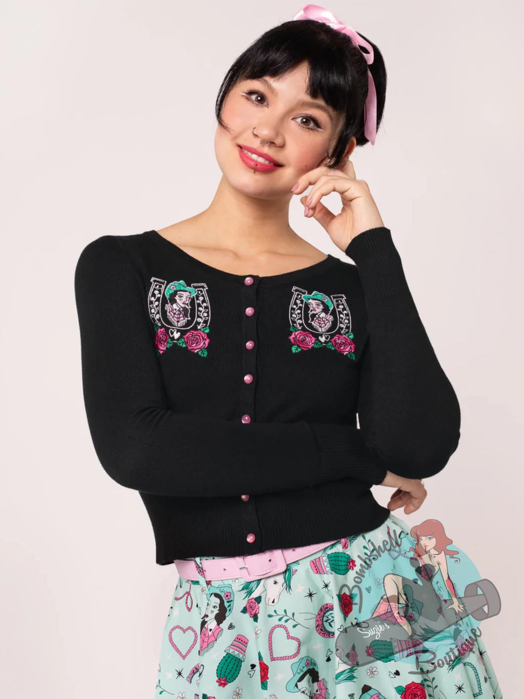 pinup girl wearing black cardigan with western queen of the rodeo embroidery