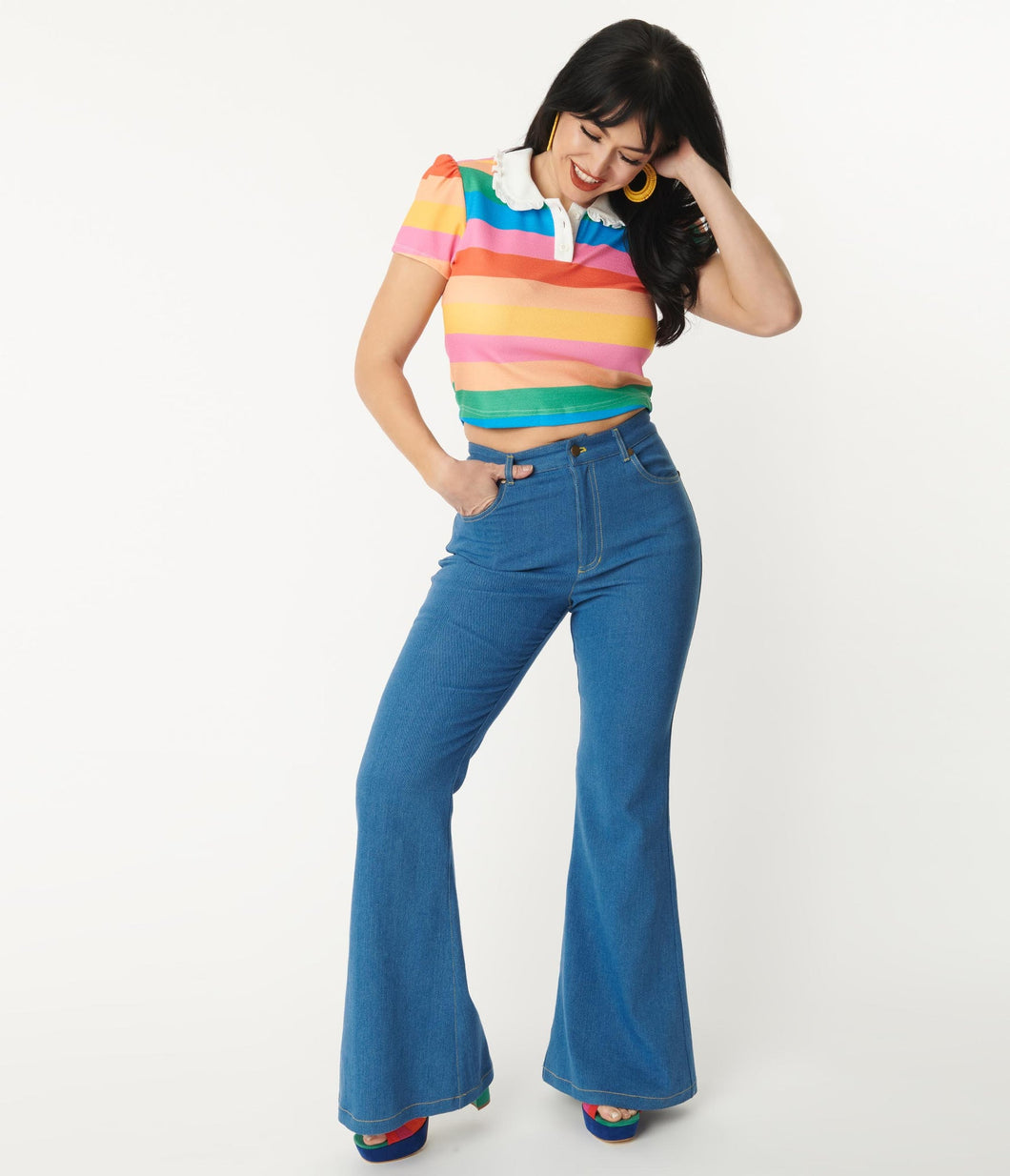 Unique Vintage for Suzie's Bombshell Boutique. Flared, 70s, denim blue jeans. Hippie jeans with rainbow embroidery.